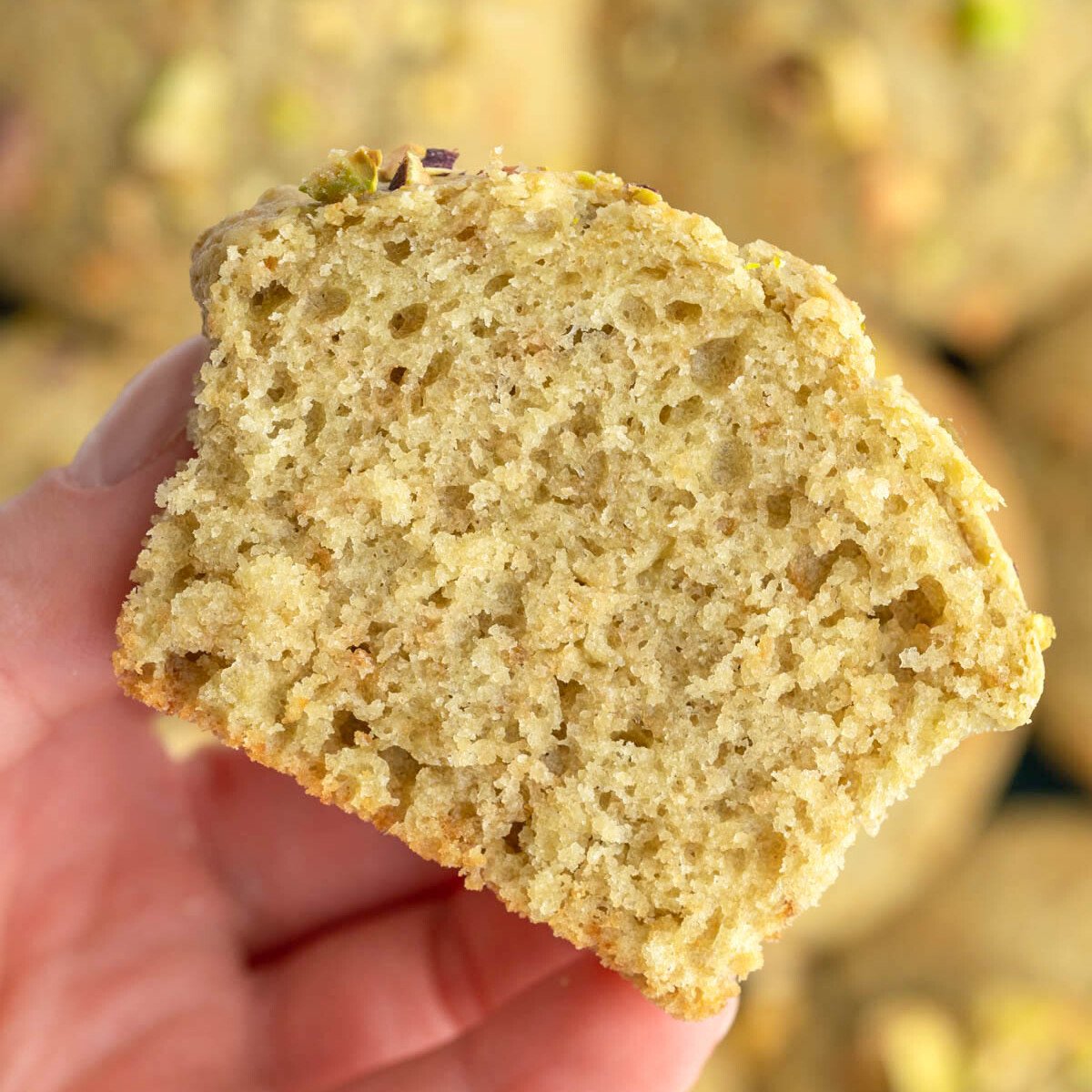 hand holding half of a muffin.