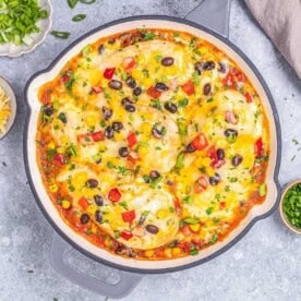 santa fe chicken breasts topped with melted cheese in a skillet.