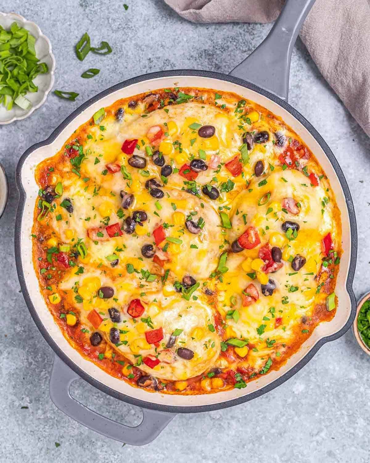 chicken breasts in a skillet with a Santa Fe sauce.