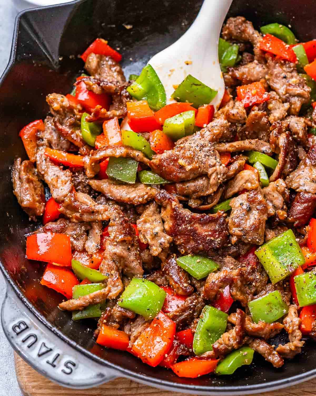 cooked peppers and steak in a skillet.