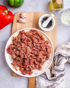 seasoned pepper beef uncooked on a plate.