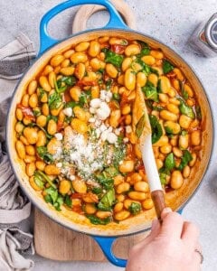fresh spinach and parmesan cheese added over the beans in skillet.