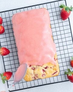 glaze being added over the strawberry pound cake.