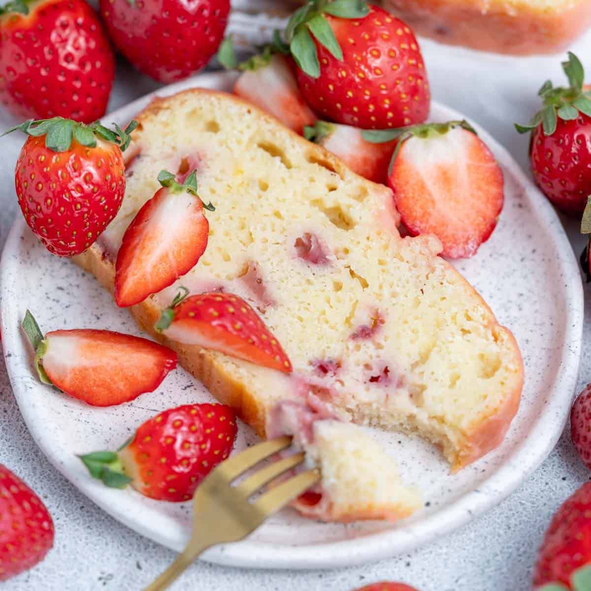 a slice of strawberry pound cake on a plate.