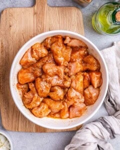 chicken chunks marinated in a bowl.
