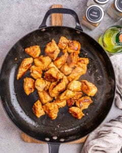 cooked chicken bites in a skillet.