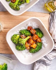 serving the tofu over rice and roasted cauliflower in a bowl.
