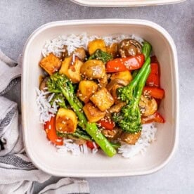 a meal pre bowl or tofu stir fry cooked with veggies served with white rice.