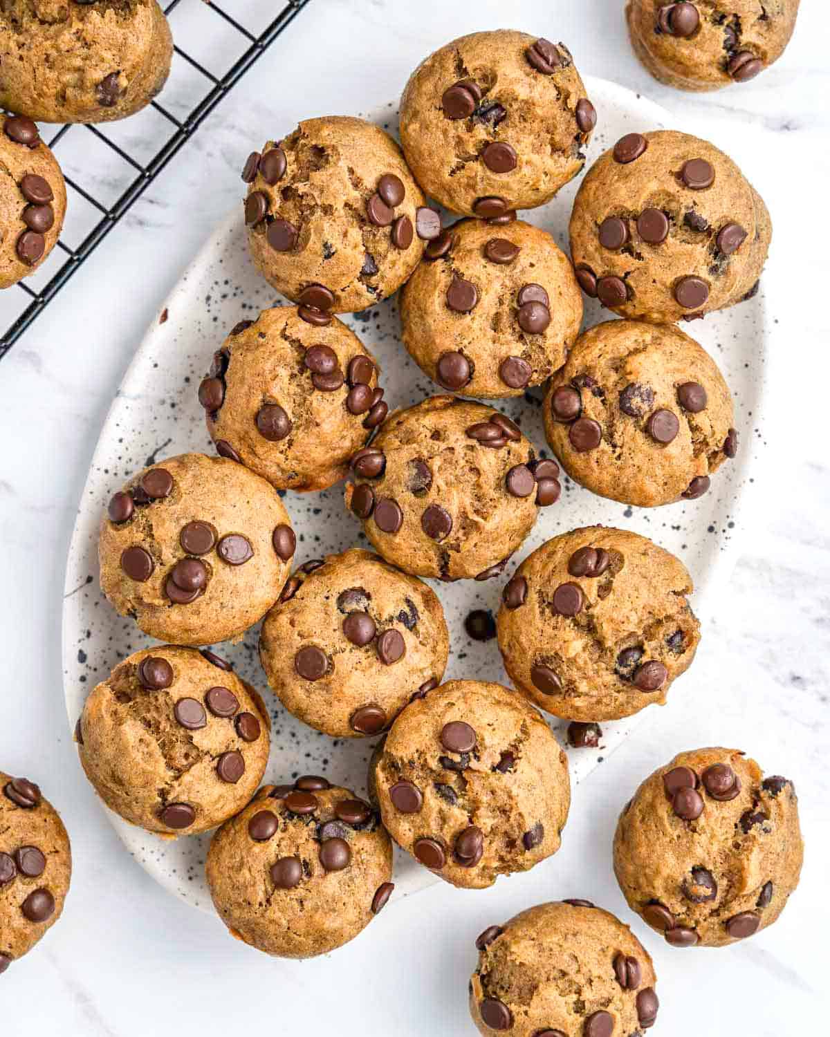 mini muffins placed on a plate made with chocolate chips.
