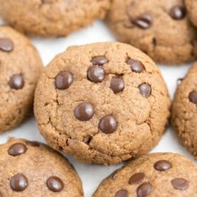 chocolate chip cookies made with almond butter on a flat surface.