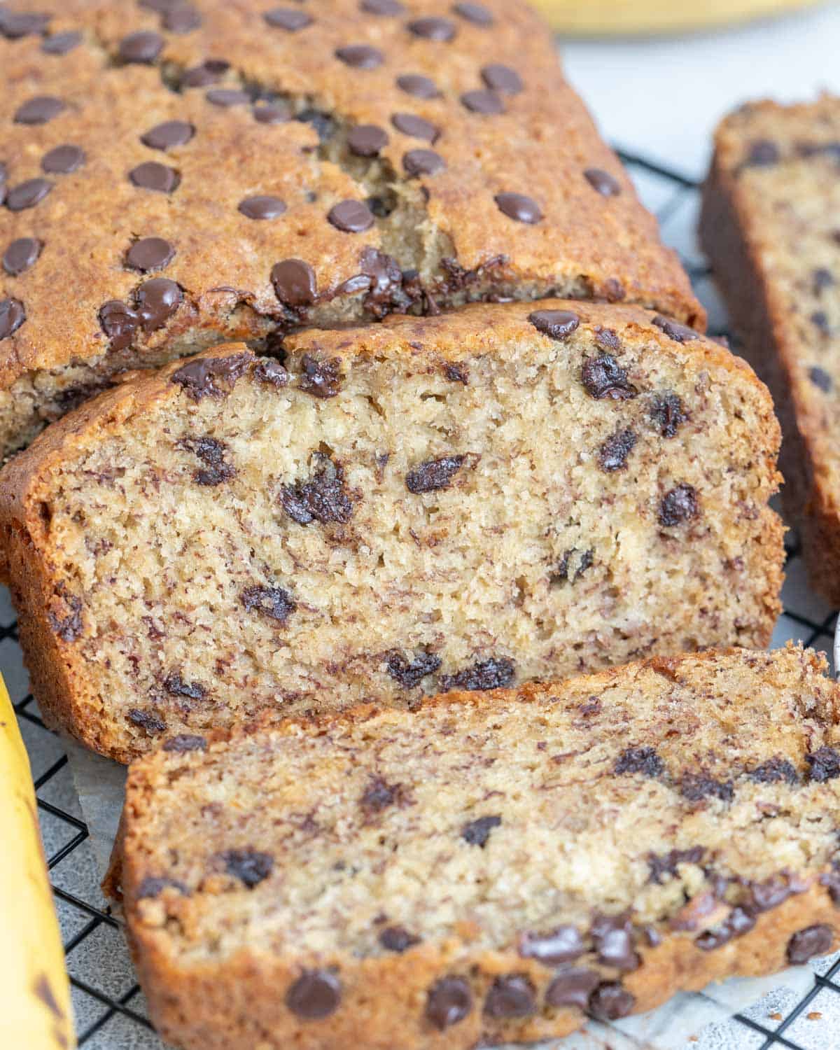 sliced banana bread on a wire rack.