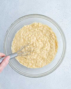 banana bread batter formed in a clear bowl.