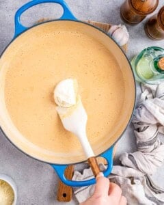 creamy cheese added to the cajun sauce in the pan.