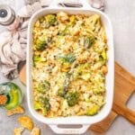 a dish with chicken divan with broccoli topped with melted cheese.