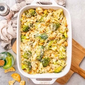 a dish with chicken divan with broccoli topped with melted cheese.