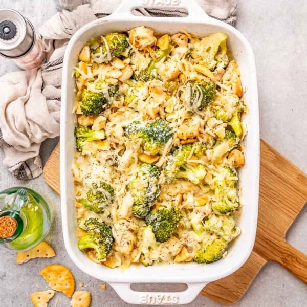 a dish with chicken divan with broccoli topped with melted cheese.