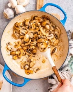 Sautéing mushrooms in a skillet.