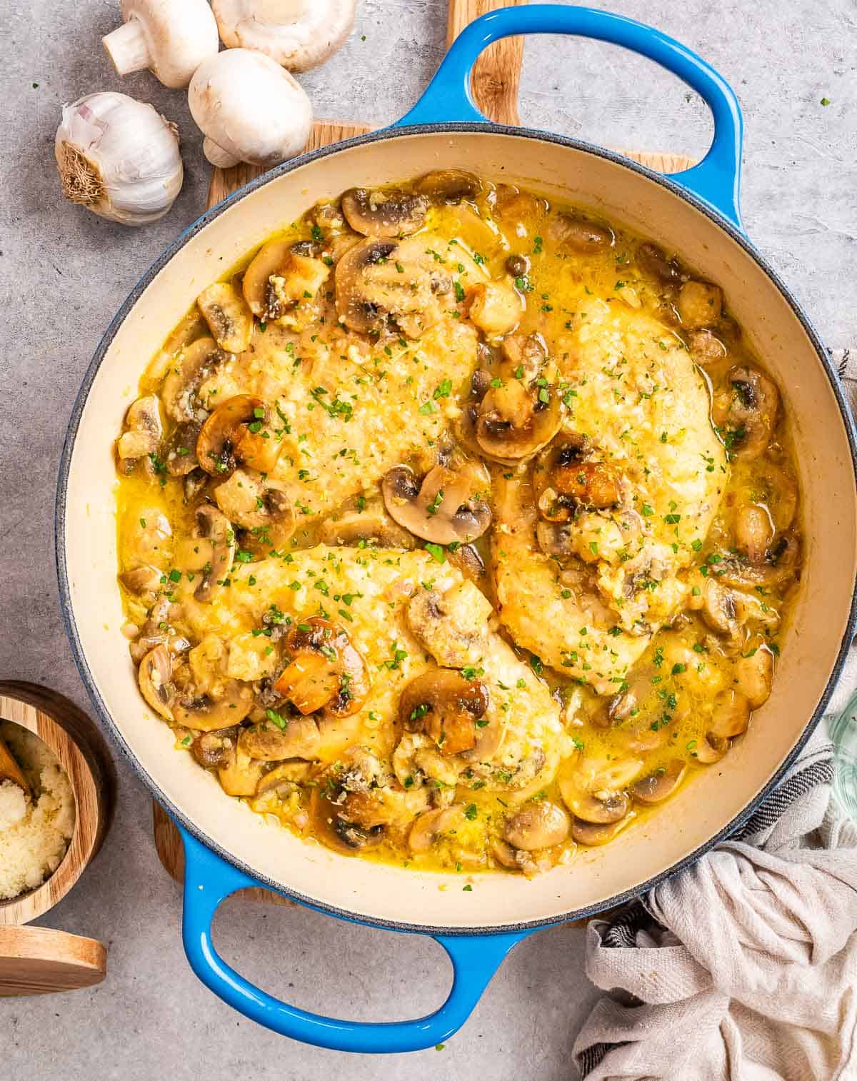 Chicken scallopini in a blue skillet.