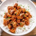 chicken vindaloo served over white rice in a bowl.