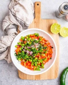 chopped salsa ingredients in a bowl.