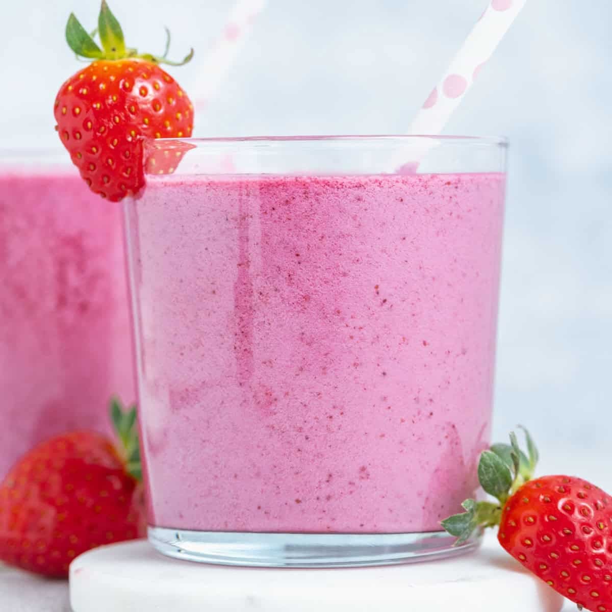a cup of smoothie that's almost purple looking.