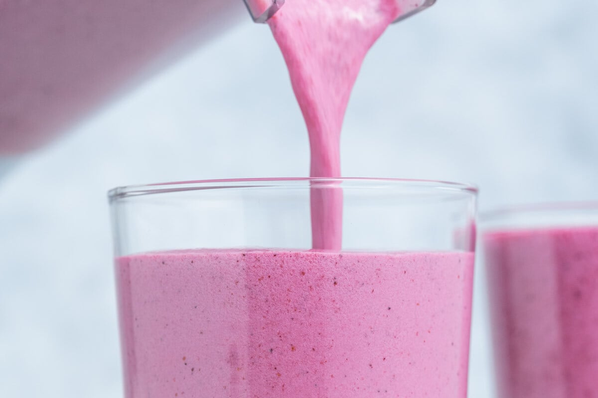 smoothie being poured into a cup.