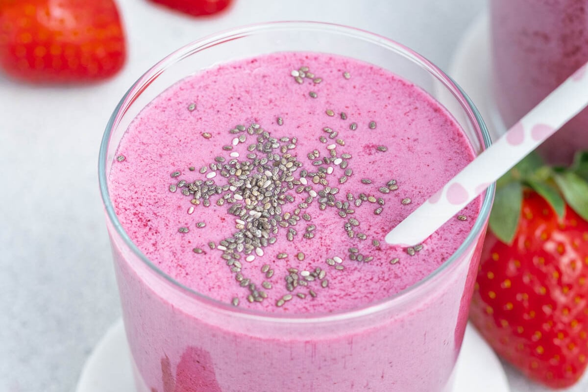 a cup of purple colored berry smoothie.