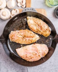 cooked chicken breasts in a skillet.