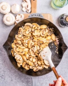 Cooking the mushrooms in a skillet.