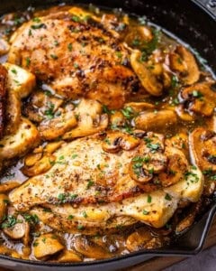 stuffed chicken breast in pan cooked in mushroom sauce.