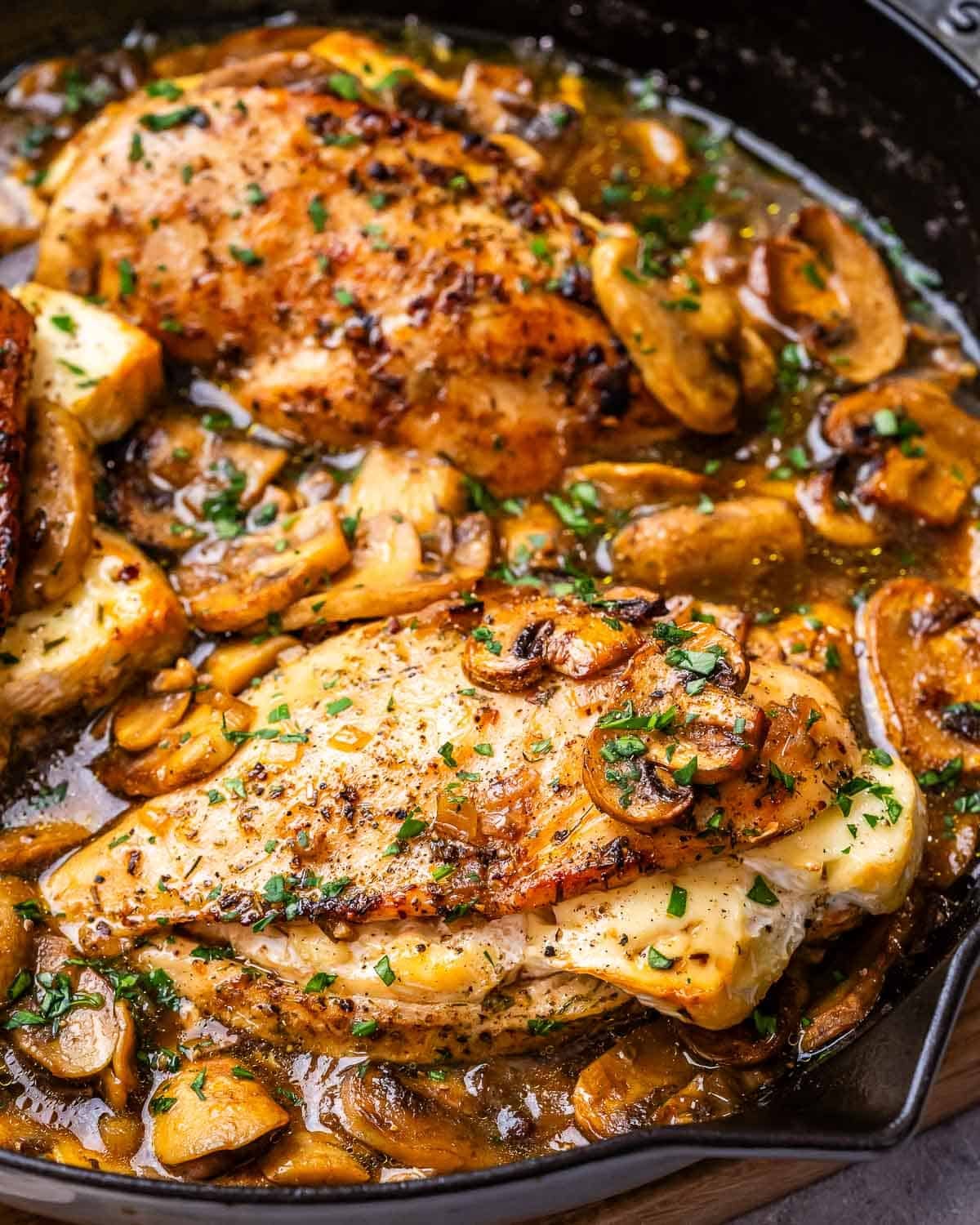 stuffed chicken breast in pan cooked in mushroom sauce.