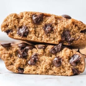 two half cookies stacked over each other with chocolate chips.