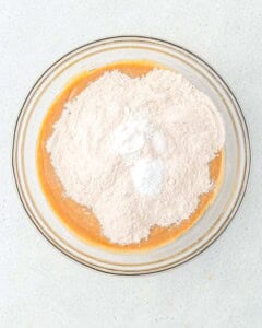 flour baking soda and baking powder added over the blended dates and milk.