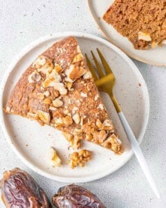 a slice of date cake served over a plate.