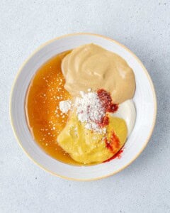 sauce ingredients for the honey mustard sauce added into a bowl.