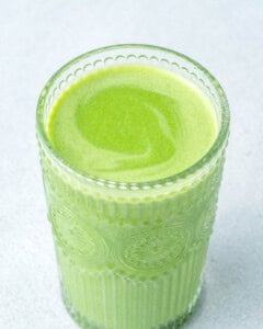 green shamrock smoothie placed in a cup.