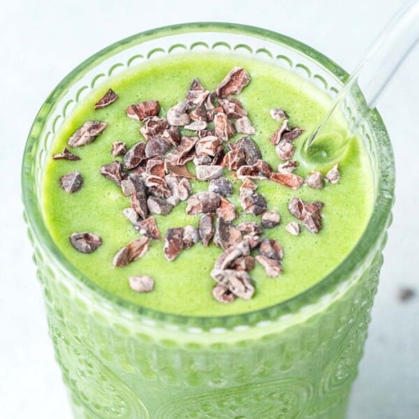 a cup full of shamrock shake topped with cocoa nibs.