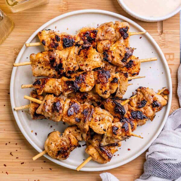 Bang Bang grilled chicken skewers on a plate.