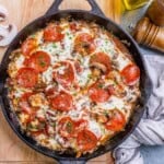 pizza looking seared and baked chicken breasts in a skillet.