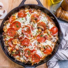 pizza looking seared and baked chicken breasts in a skillet.