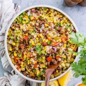 a round bowl filled with cowboy pasta salad made with ground beef, veggies, and pasta.