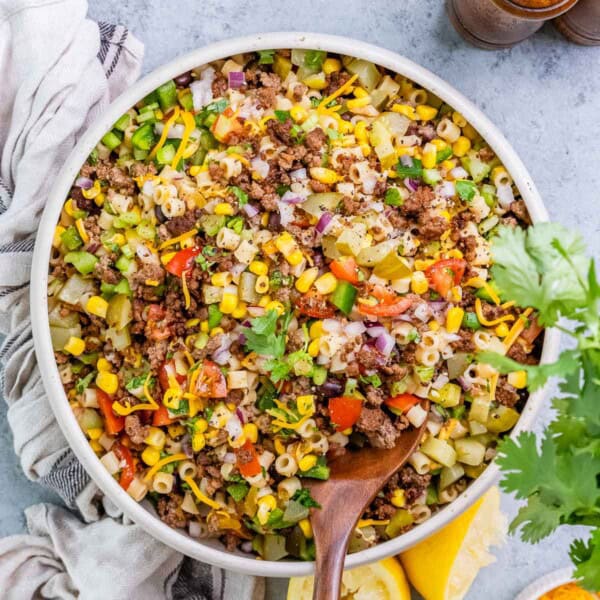 a round bowl filled with cowboy pasta salad made with ground beef, veggies, and pasta.