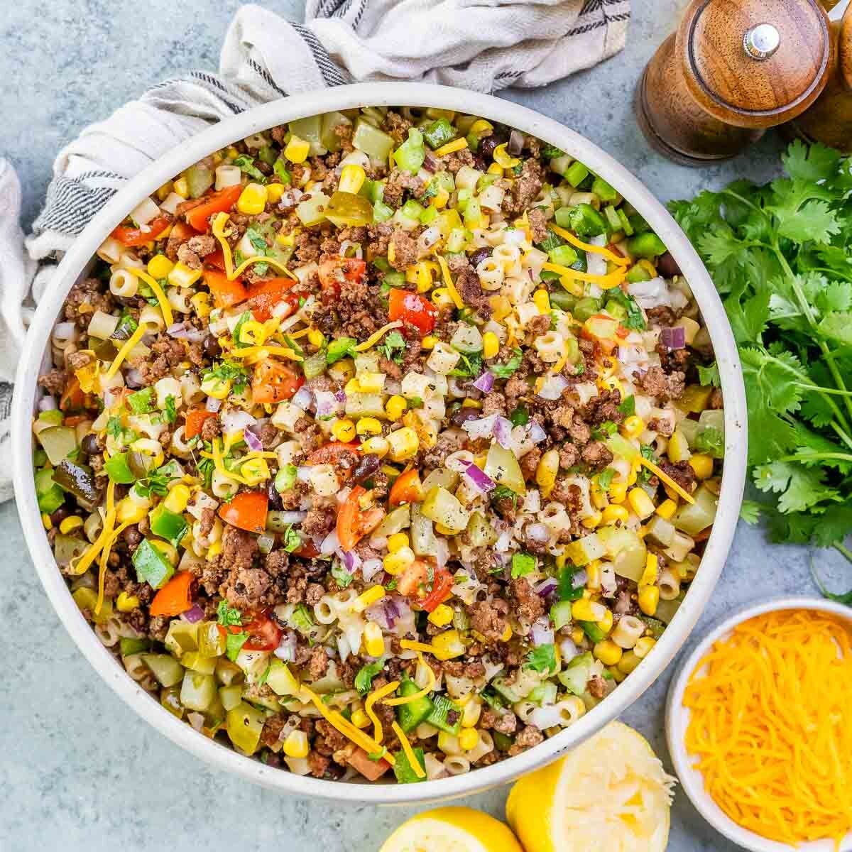 a bowl with pasta salad and ground beef.