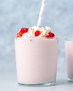 serving a strawberry smoothie in a cup.