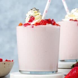 a cup filled with a strawberry smoothie.