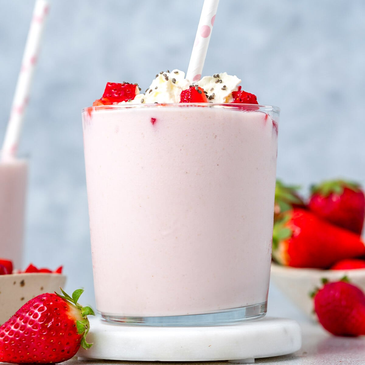 strawberry smoothie with a straw in the cup.