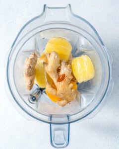 ingredients to make lemon ginger shots placed in a blender.