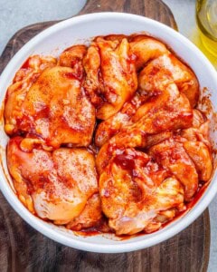 marinated chicken thighs in a bowl.