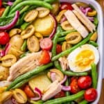 Nicoise salad in a white dish.