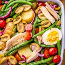 Nicoise salad in a white dish.